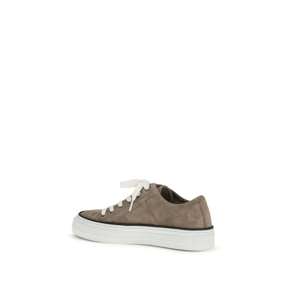 Brunello Cucinelli beige suede low-top sneaker with white laces and a thick white rubber sole.