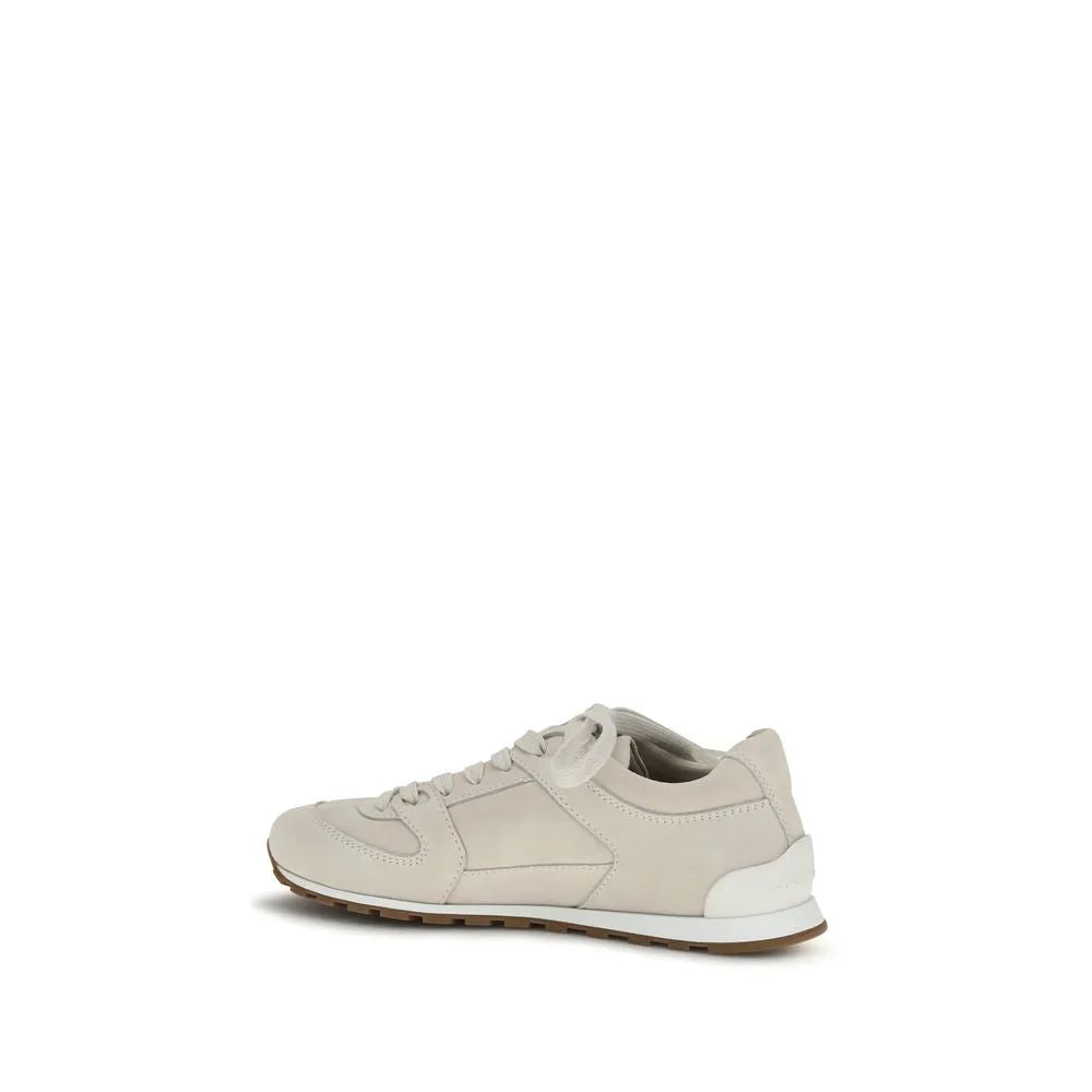Brunello Cucinelli beige suede and leather low-top sneakers with white laces, rounded toe, and rubber sole.