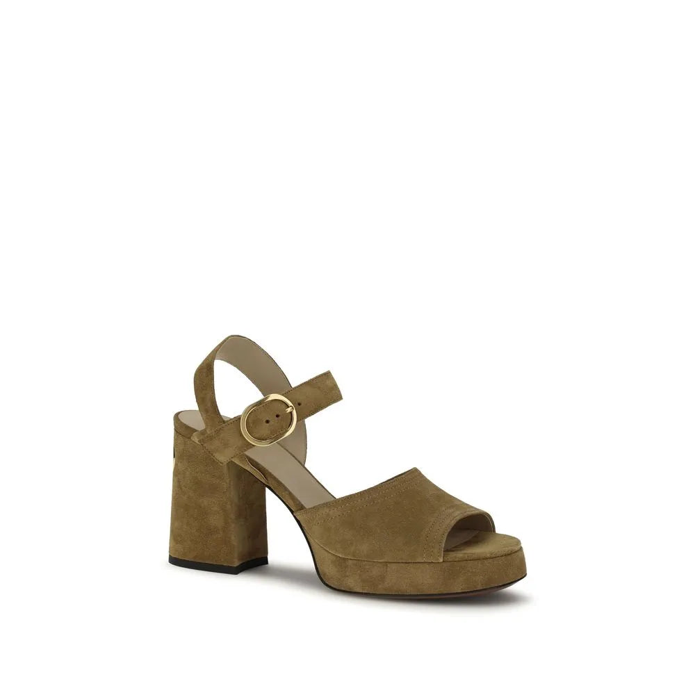 Beige suede platform sandal with thick block heel, open toe, and adjustable ankle strap with brass buckle.