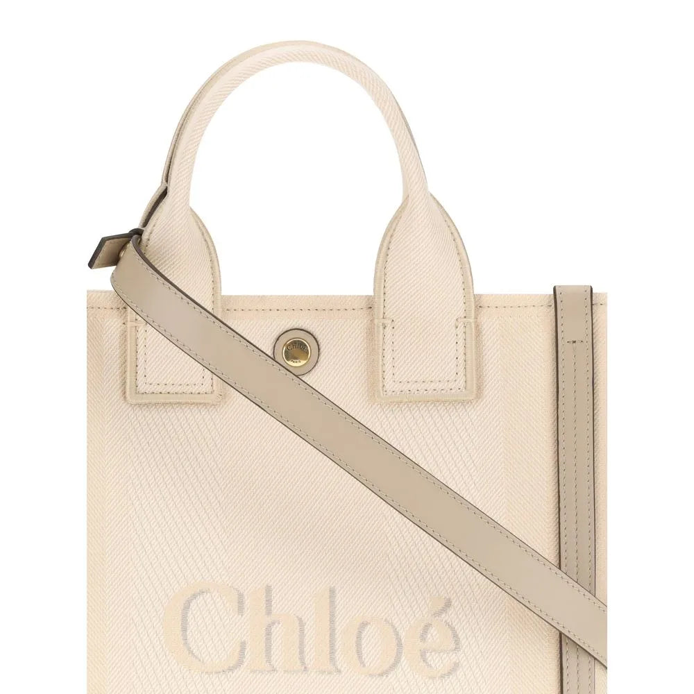 Beige Chloé cotton tote bag with textured weave, light tan leather details, double handles, and prominent front logo.