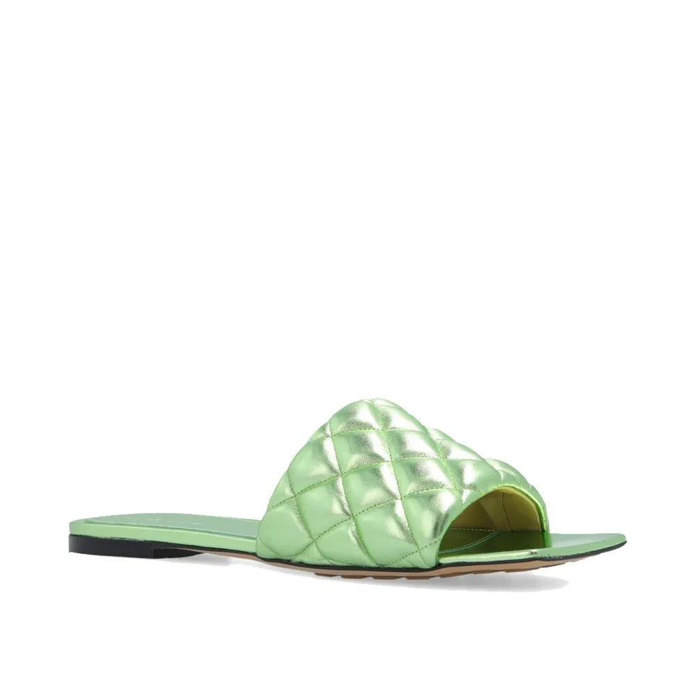 Metallic green quilted calfskin slide sandal with a wide padded strap and flat sole.
