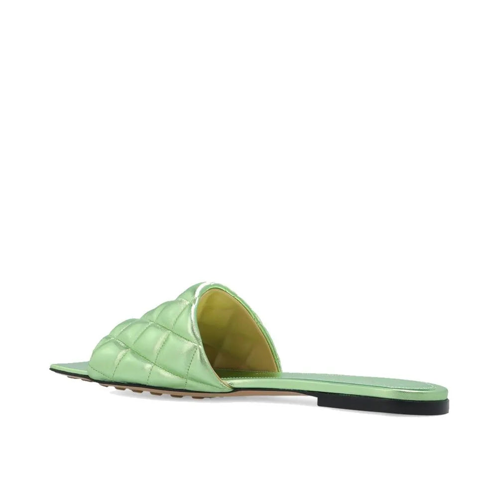 Metallic lime green quilted calfskin slide sandal with a contrasting golden-green lining and flat sole.