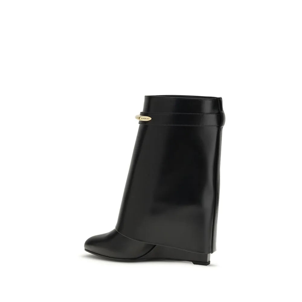 Black calf leather Givenchy Shark ankle boot with pointed toe, covered wedge heel, and gold GIVENCHY clip.
