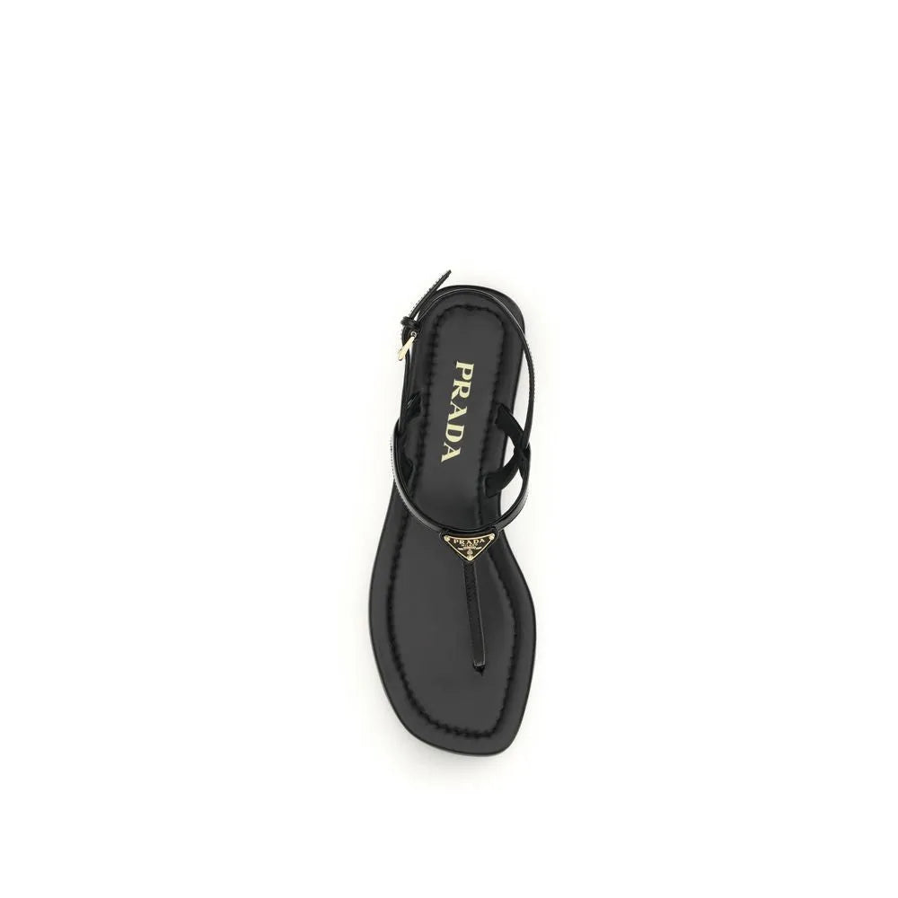 Black patent calf leather Prada flip-flop sandal with gold triangle logo, adjustable ankle strap, and round toe.