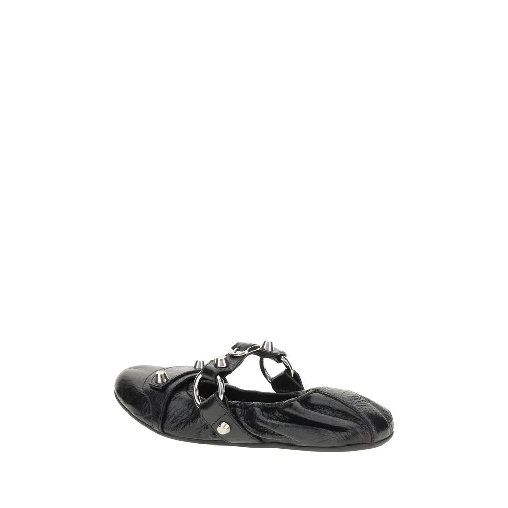 Black lambskin ballet flats with silver studs, rings, and a rounded toe. Features an elastic back.