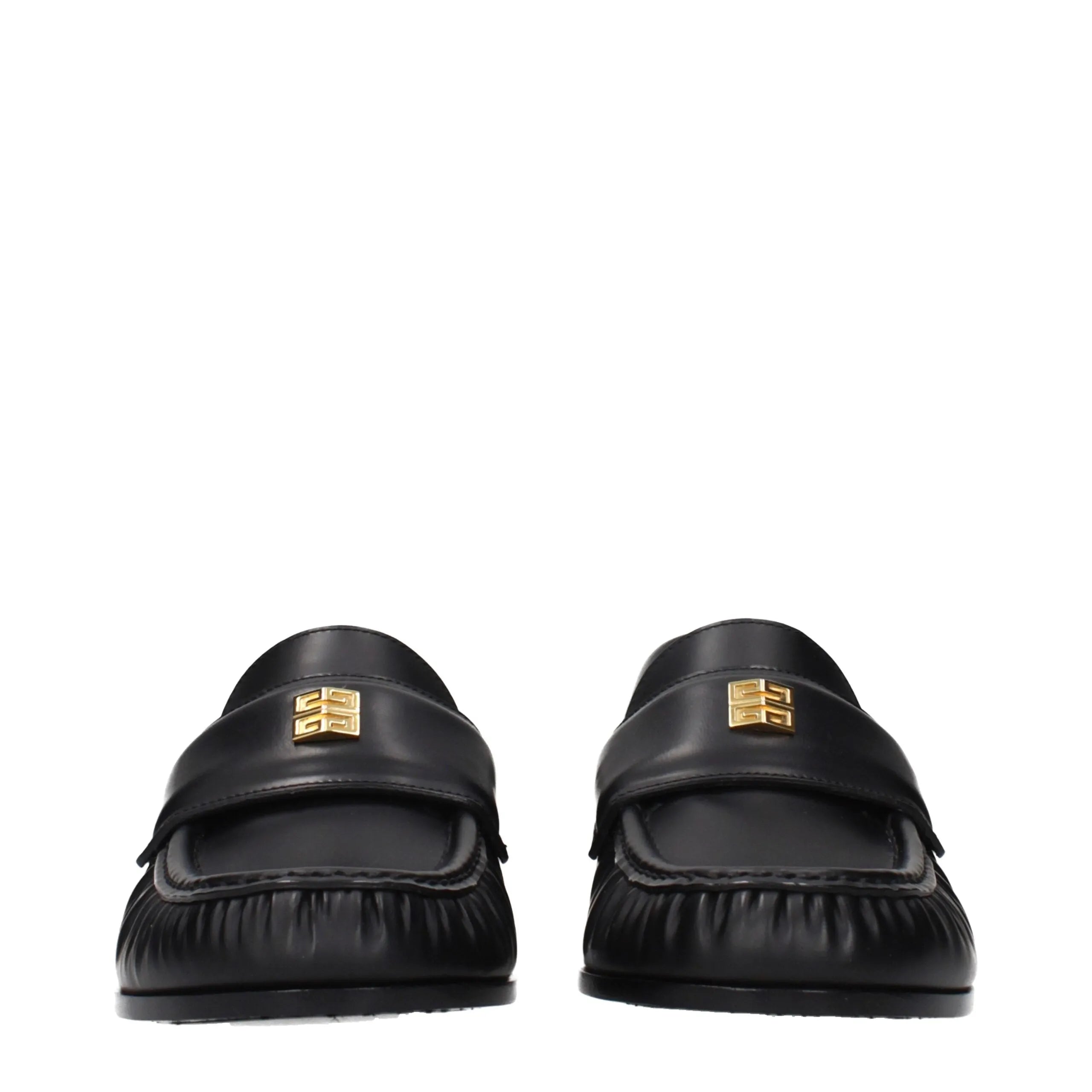 Black leather slip-on loafers by Givenchy with gold 4G logo hardware on the front.