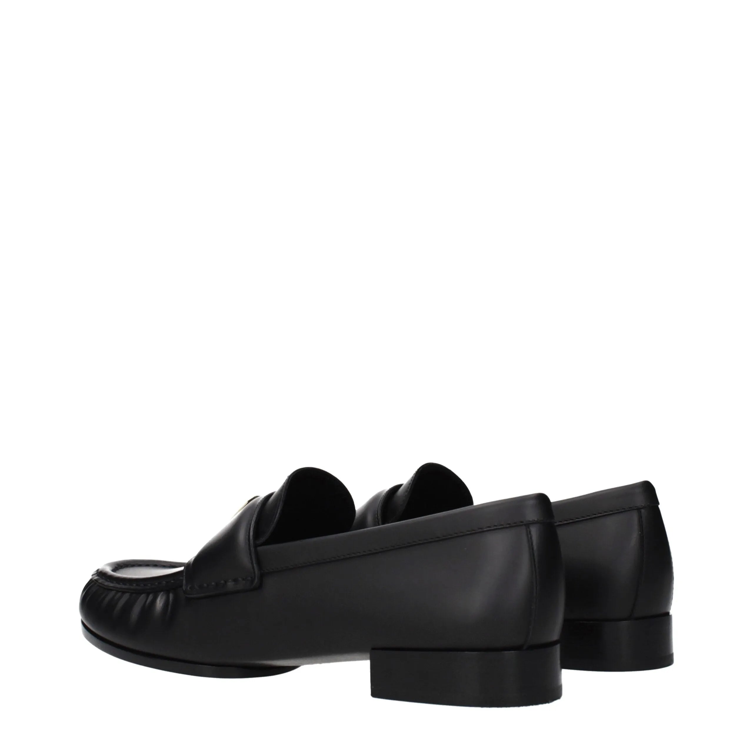 Givenchy black leather slip-on loafers with a front logo, shown from a rear-side angle.