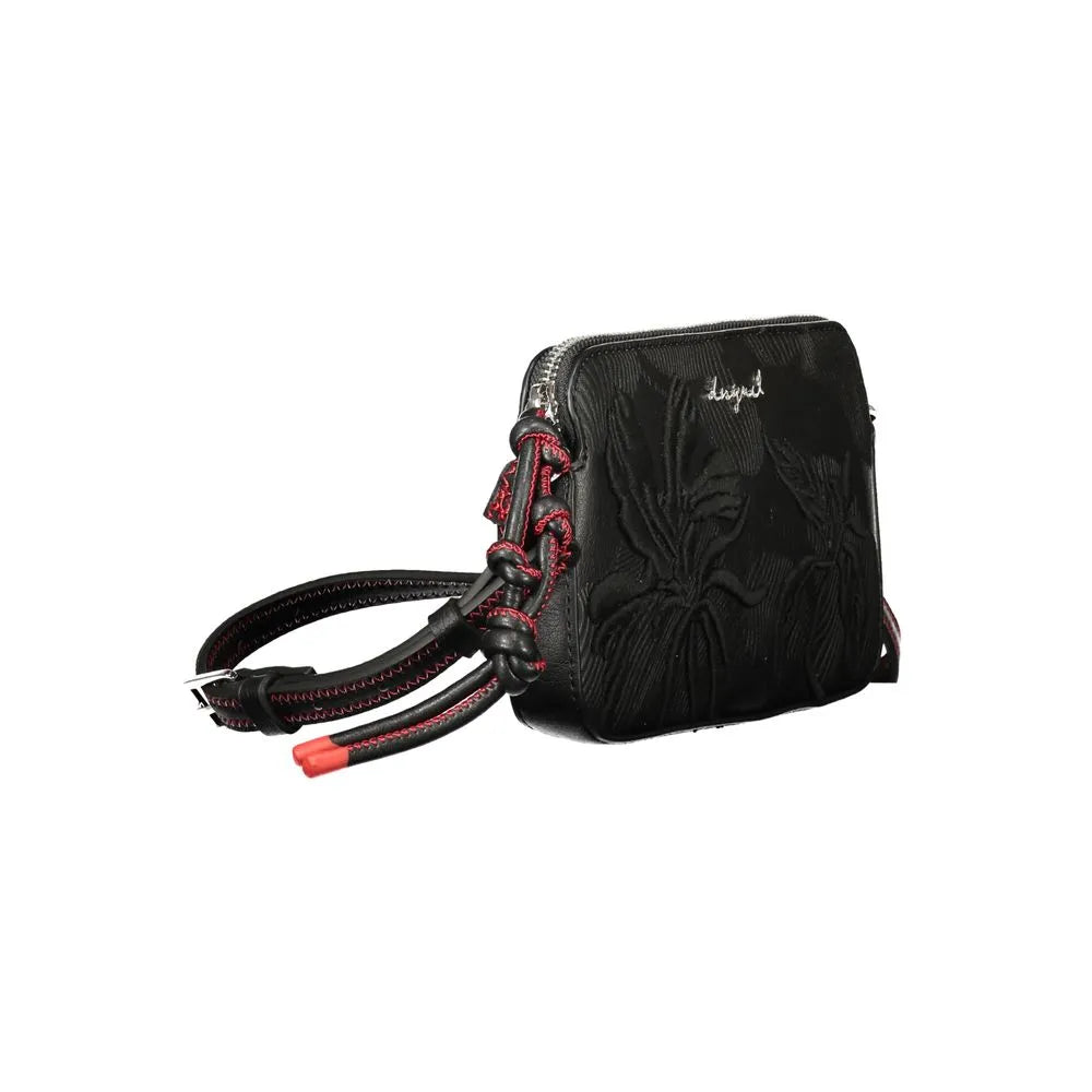 Black Desigual polyurethane women's handbag with embossed floral design and red accented adjustable strap.