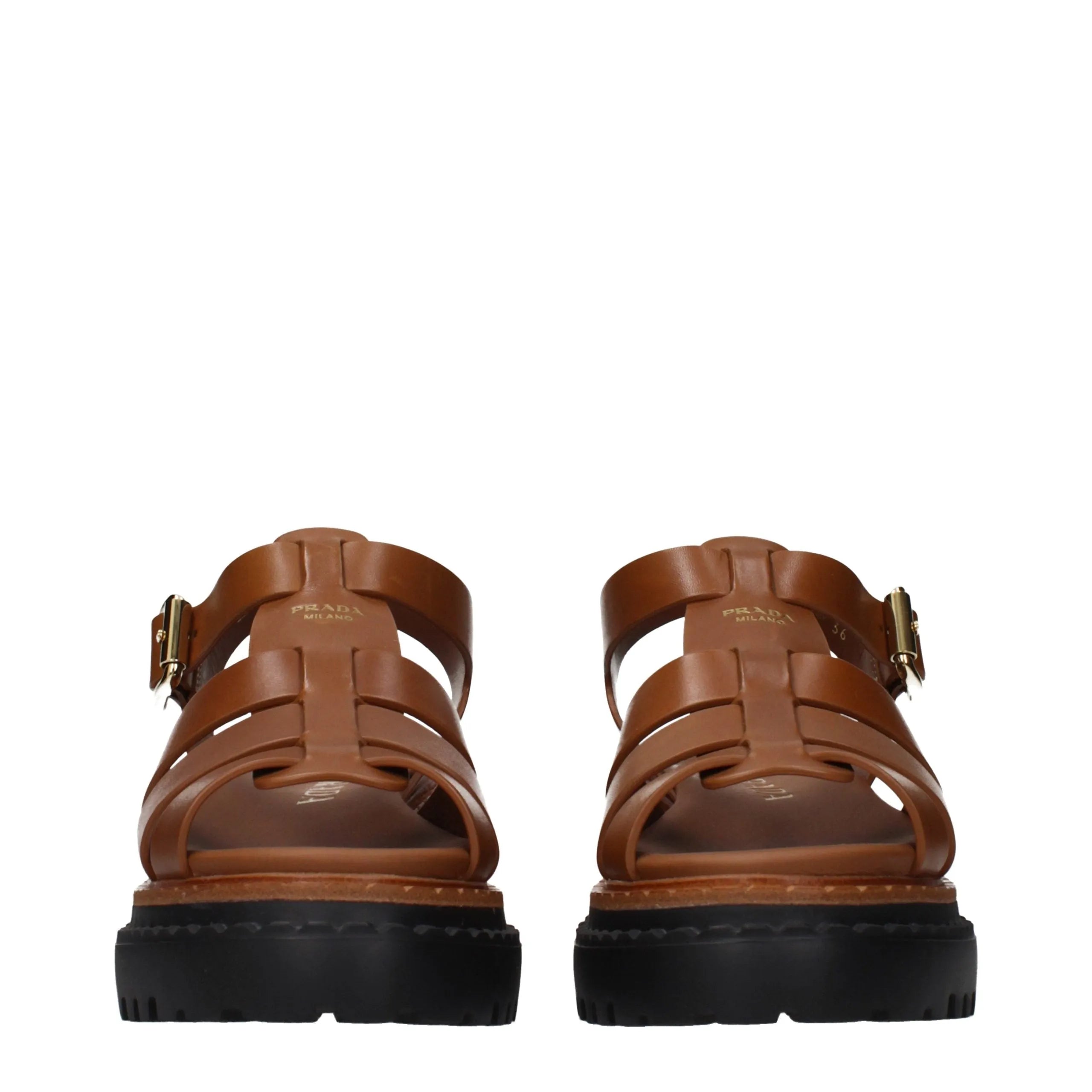 Prada brown leather platform sandals with gladiator straps, front logo detail, and chunky black sole.