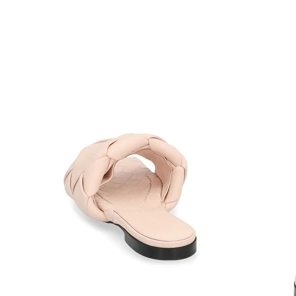 Women's light pink leather flat sandal with a wide, puffy braided strap, square toe, embossed insole, and dark rubber sole.