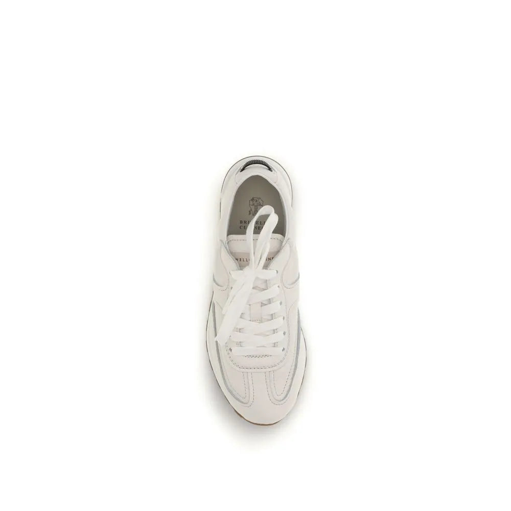 Brunello Cucinelli white calf leather low-top sneakers with lace-up front, subtle logo, and rubber sole.
