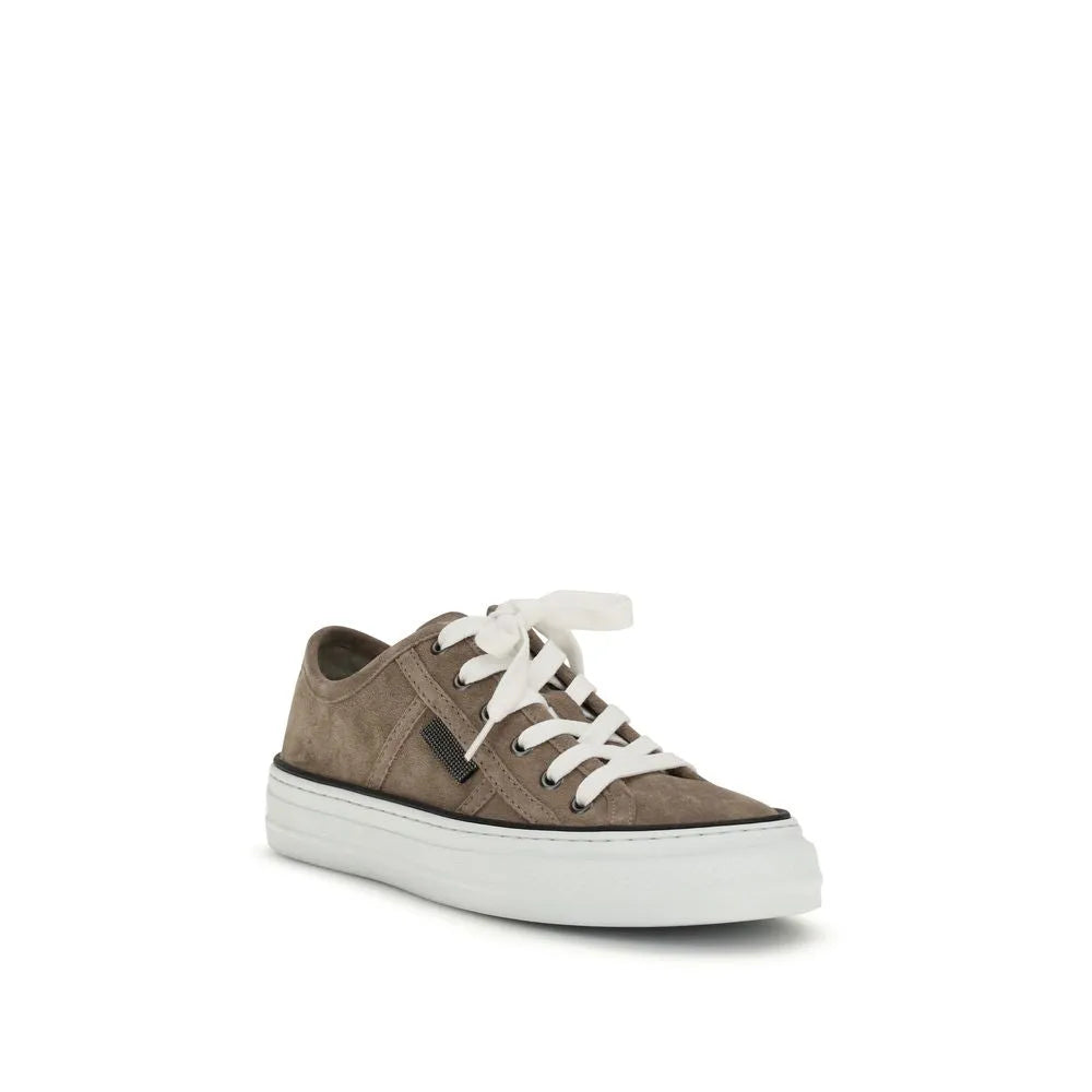 Beige calf leather suede low-top sneaker with white laces, thick white rubber sole, and dark metallic accent.