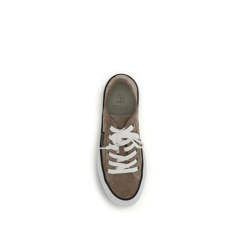 Brunello Cucinelli beige suede low-top sneaker featuring white laces, a side zipper, and a white rubber sole with a black trim.