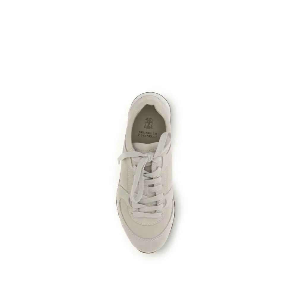 Beige Brunello Cucinelli suede low-top sneakers with laces and rubber sole.