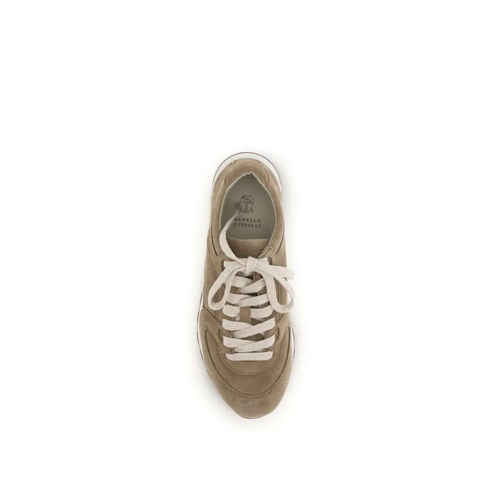 Brunello Cucinelli beige suede low-top sneakers with cream laces, rounded toe, and white rubber sole.