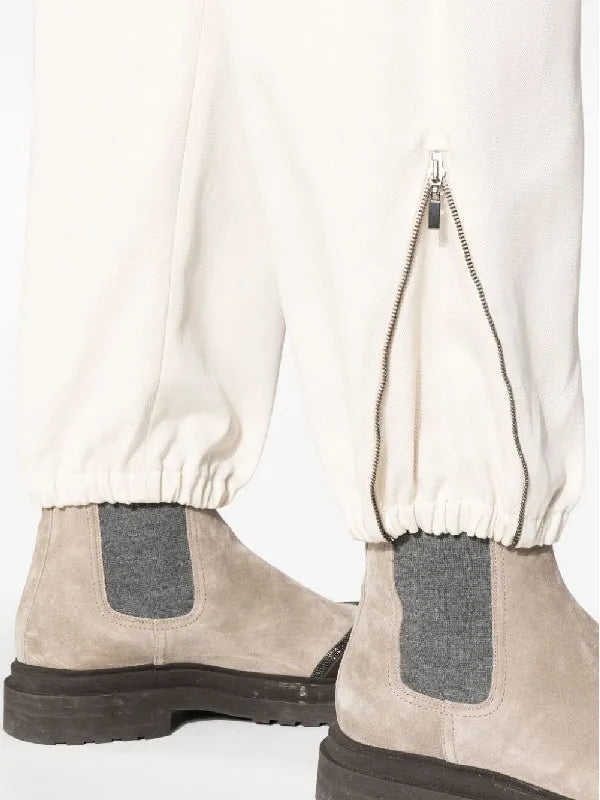 BRUNELLO CUCINELLI women's soy cotton casual pants with elastic cuffs and silver ankle zippers, styled with boots.
