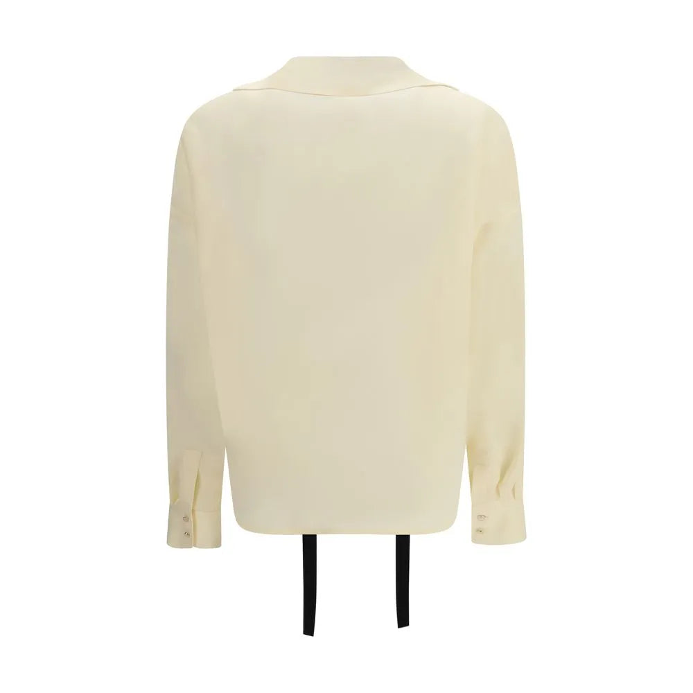 Back of an ivory pure silk blouse with a relaxed fit, long sleeves, high cuffs, and straight hem.