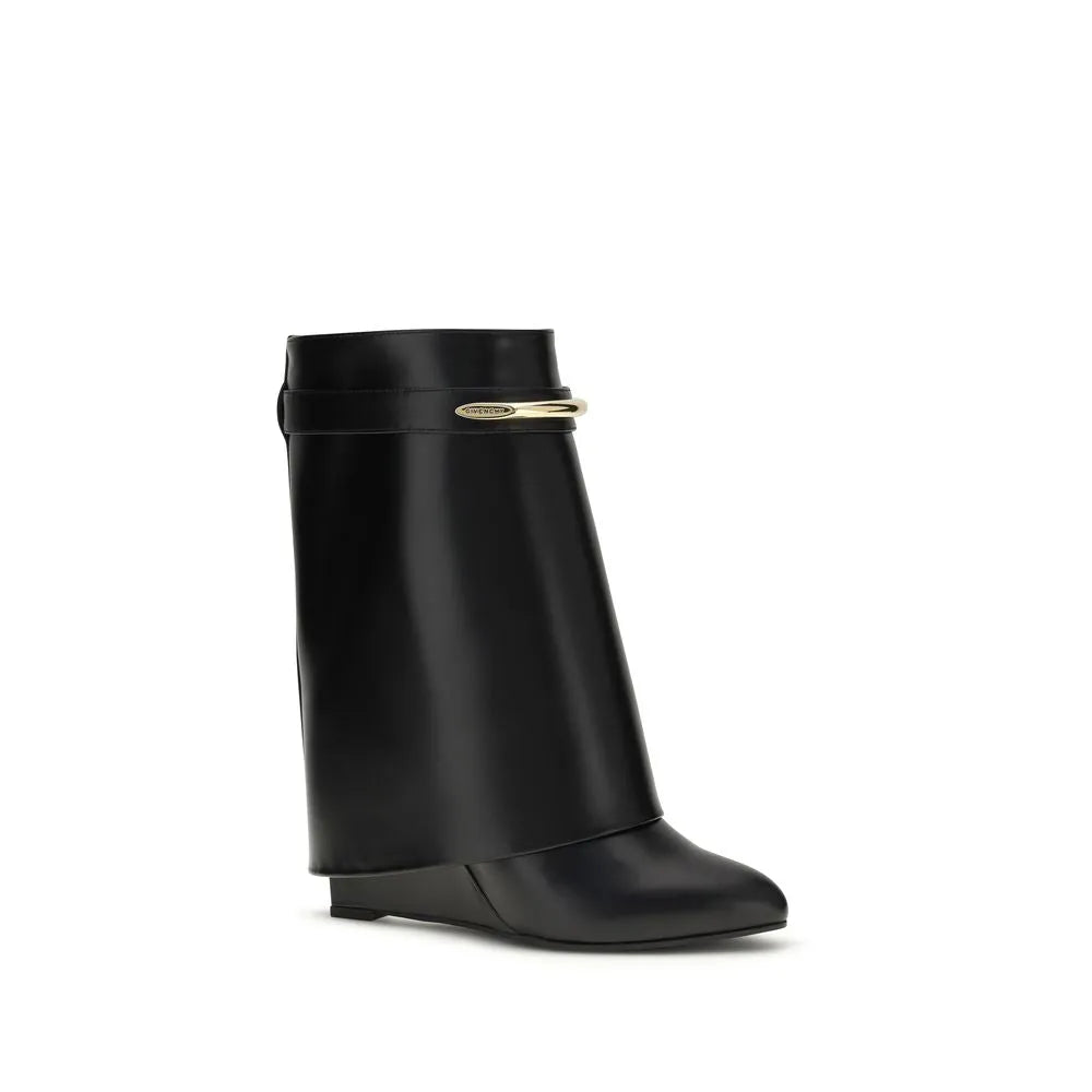 Black calf leather Givenchy Shark ankle boot with gold GIVENCHY clip, pointed toe, and covered wedge heel.