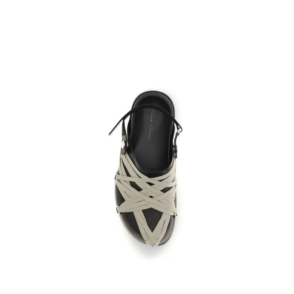 Black calf leather mule with light grey criss-cross Megalace straps, creating a harness effect.