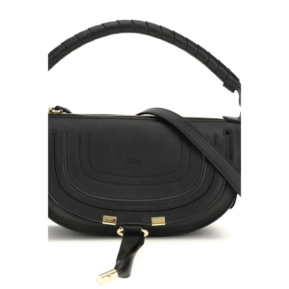 Black Chloé Marcie mini calf leather shoulder bag featuring saddle stitching, a wrapped top handle, gold hardware, and a tassel.