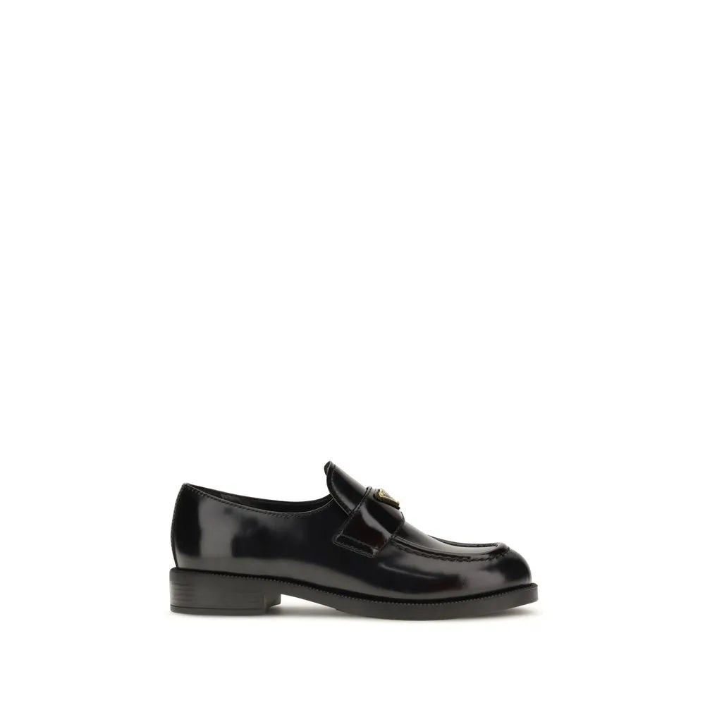 Black glossy calf leather slip-on loafer with a metal triangle logo on the saddle and rounded toe.