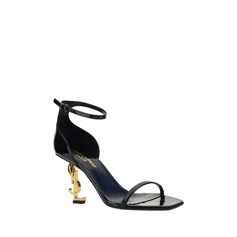 Black patent calf leather Saint Laurent Opyum sandals with gold YSL logo heel, ankle strap, and square toe.