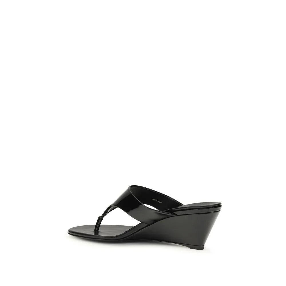 Black patent calf leather thong wedge sandal with a round toe.