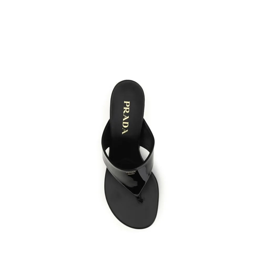 Elegant black patent leather Prada thong wedge sandals with gold logo on insole.