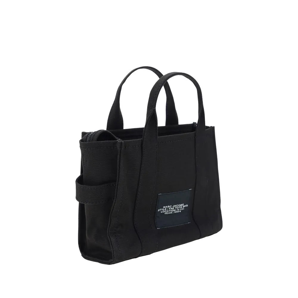 Black Marc Jacobs cotton small Tote Handbag with rigid handles, top zipper, and front logo patch.