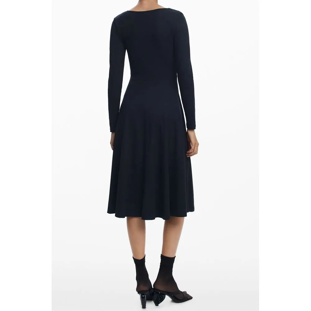 Woman's back in a black cotton blend long-sleeve midi dress with a wide neckline and flowing A-line skirt.