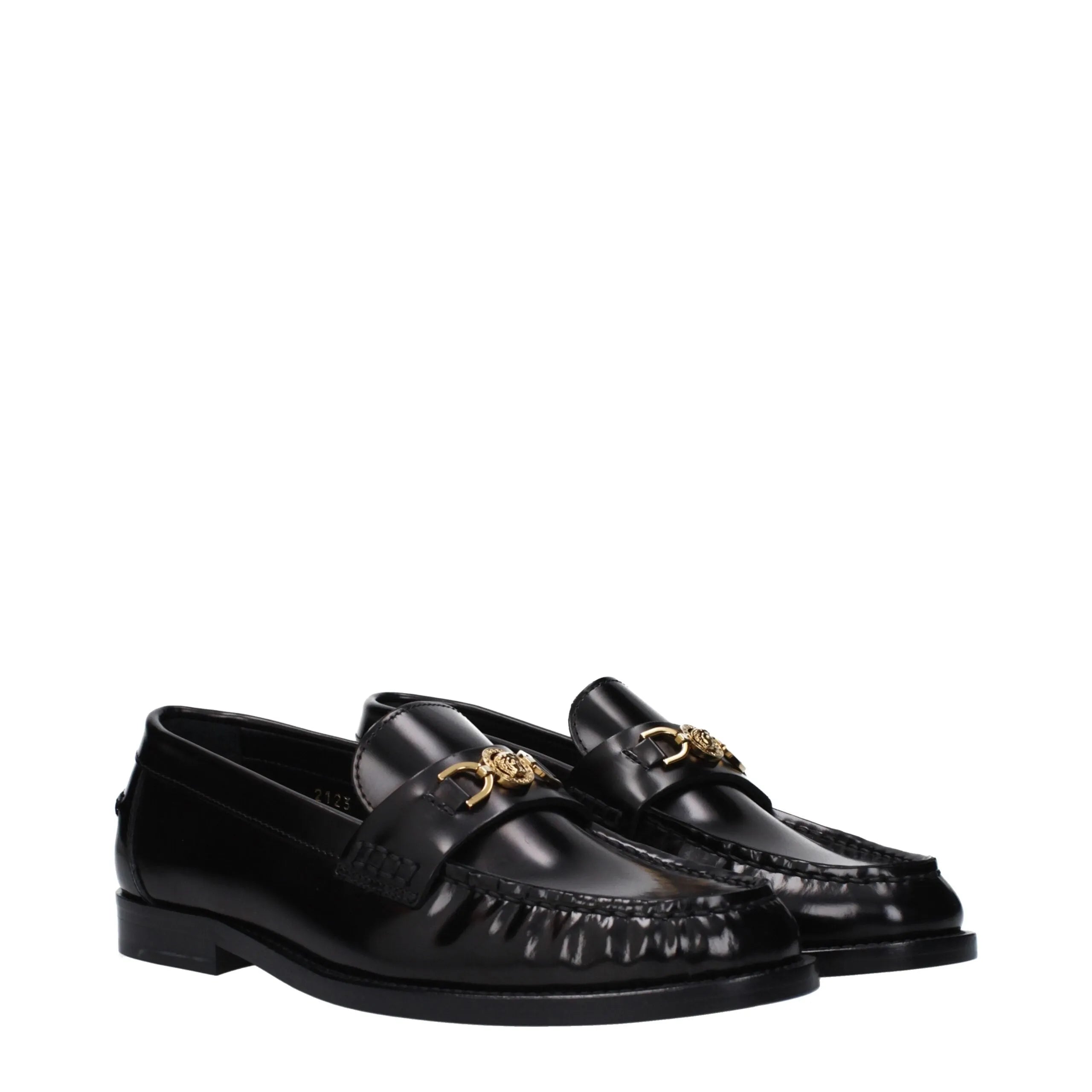 Shiny black leather Versace slip-on loafers with gold Medusa logo and classic round toe.