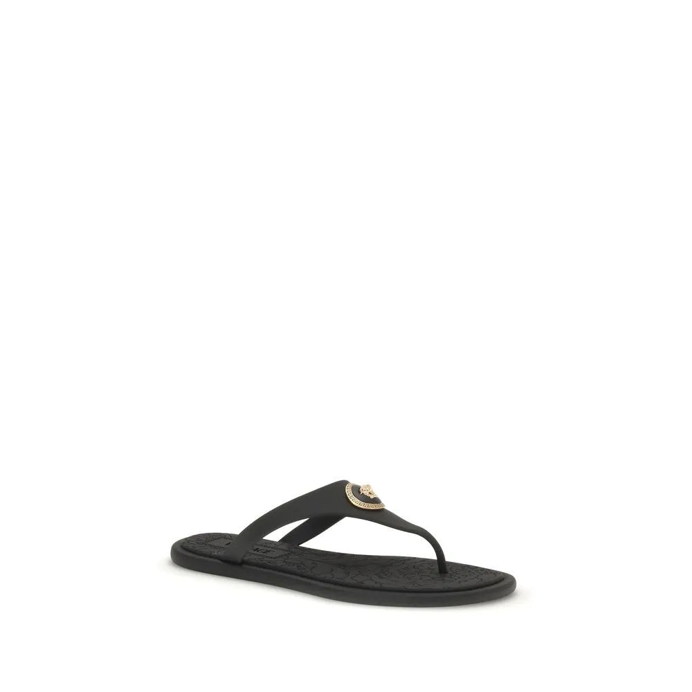 Black rubber Versace flip-flop sandal with gold Medusa emblem on the strap.