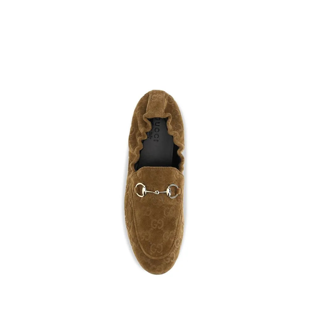 Brown calf suede Gucci slip-on loafer with embossed GG motif and silver-toned horsebit.