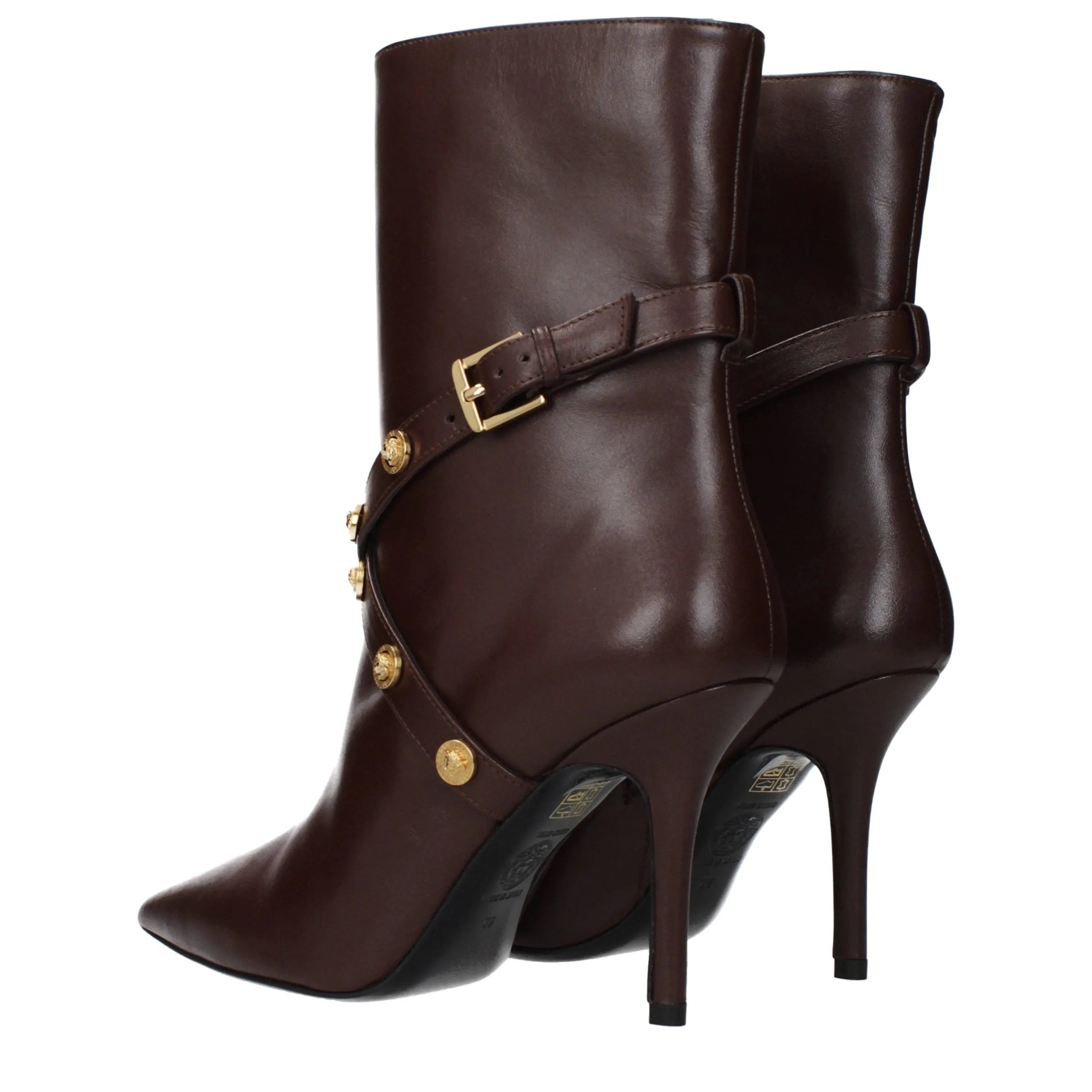 Dark brown leather Versace ankle boots with pointy toe, high stiletto heel, and decorative gold buckles and buttons.