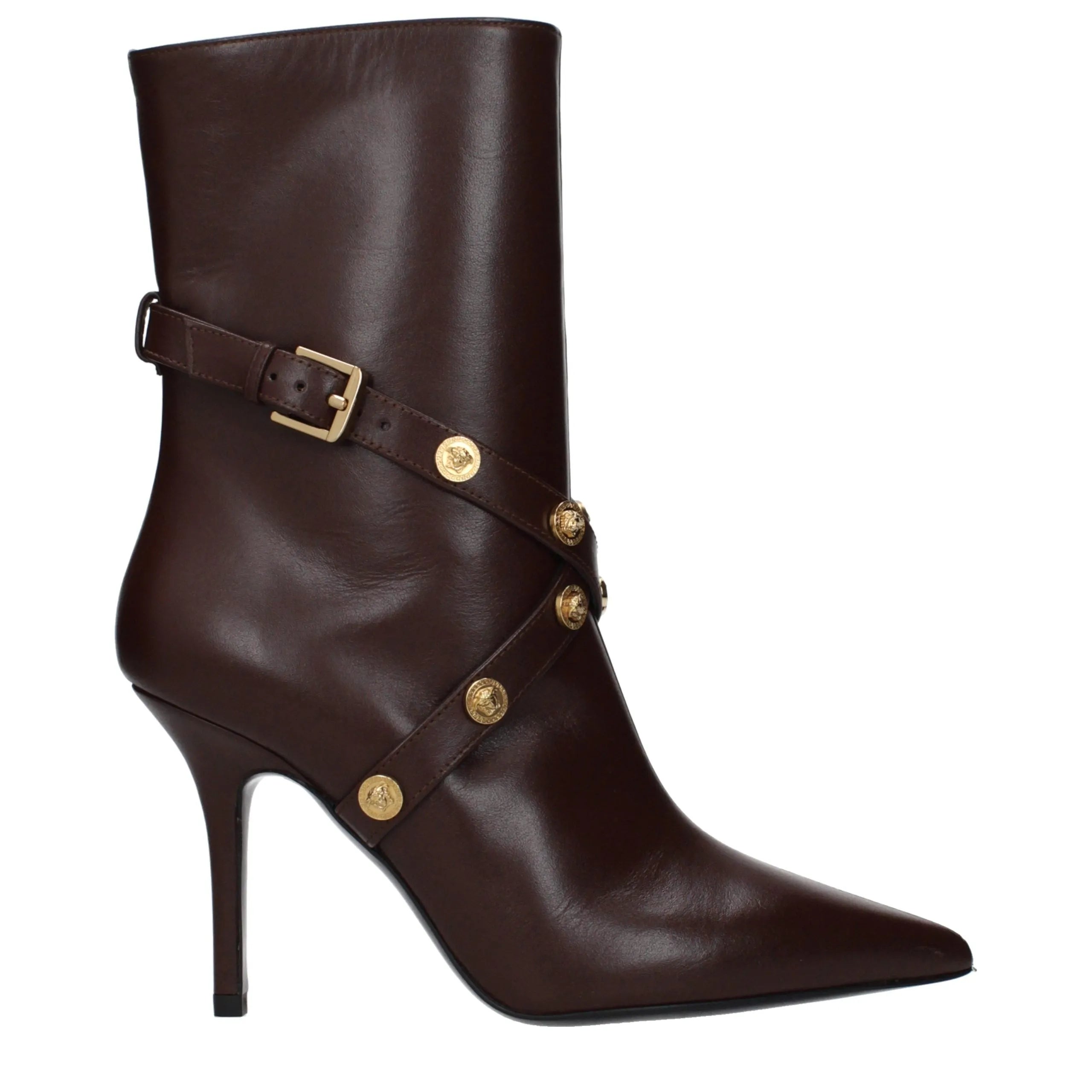 Dark brown leather ankle boot with gold buckle strap and Medusa head studs, pointy toe, high heel.