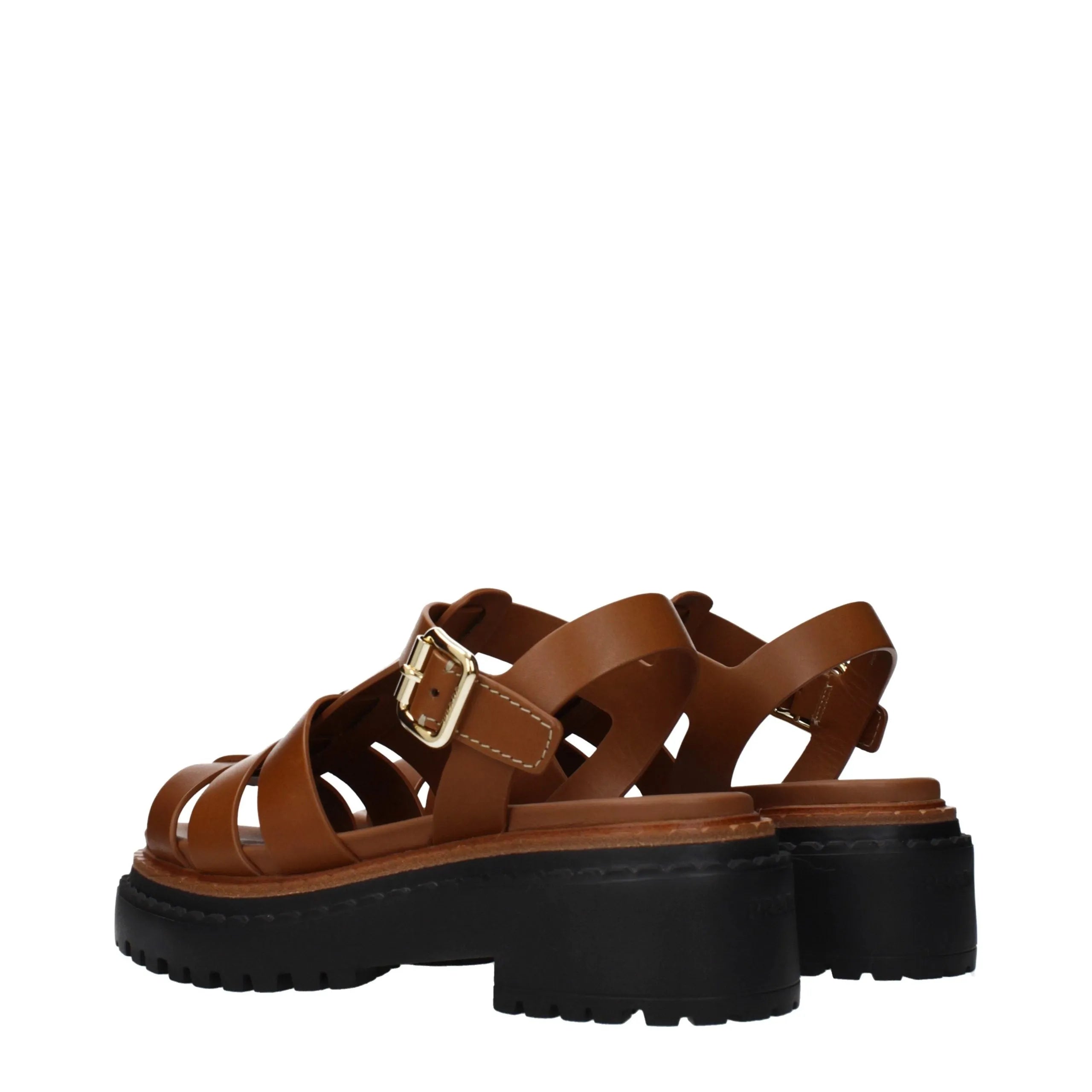 Prada brown leather platform sandals with caged straps, chunky black sole, and gold buckle.