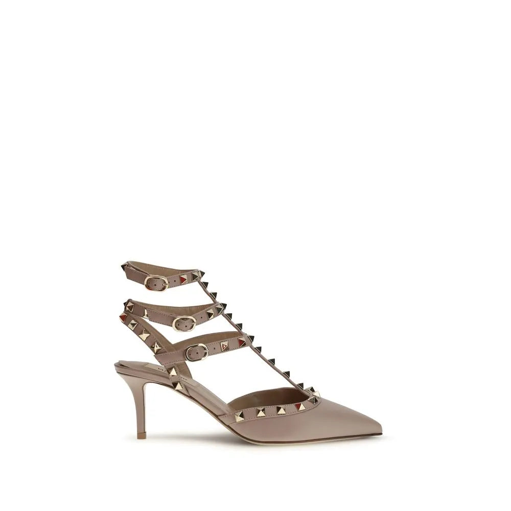 Valentino Garavani Rockstud nude calf leather pump with pointed toe, mid stiletto heel, and studded ankle straps.