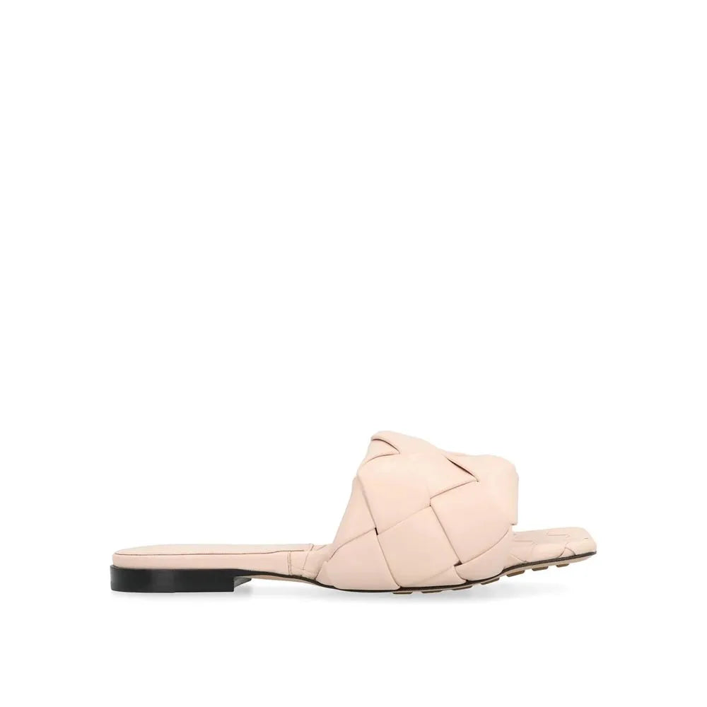 Women's nude leather flat sandal with a wide, braided strap and square toe.