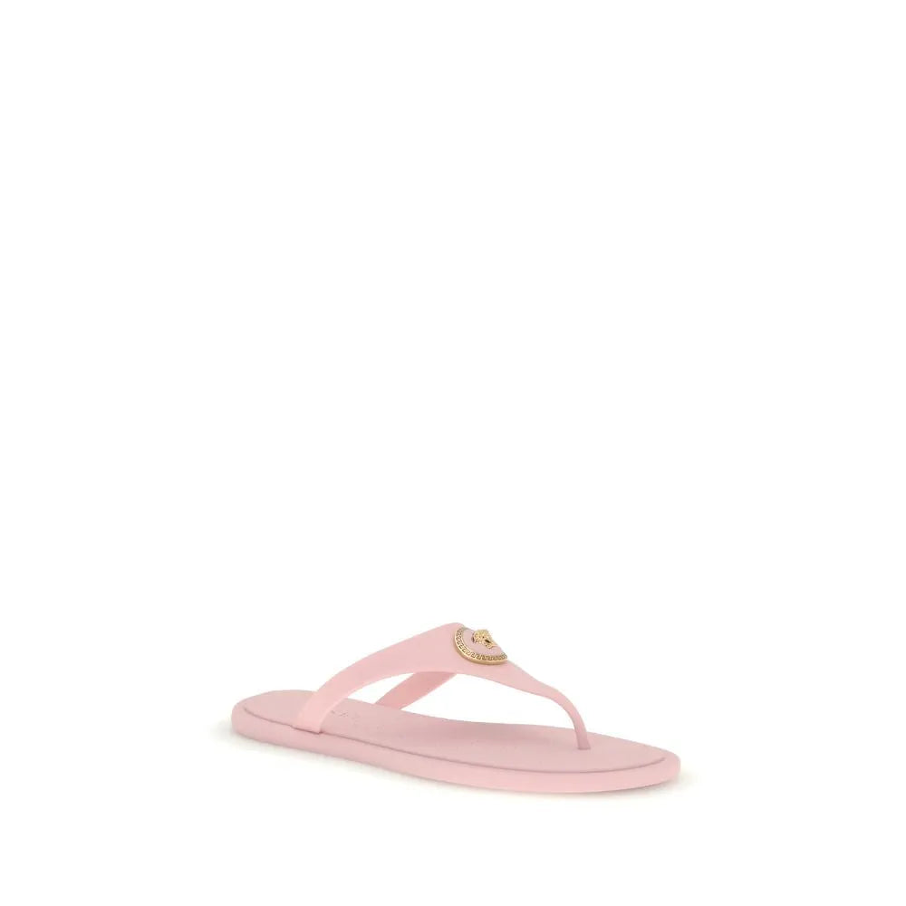 Pink rubber Versace thong sandal with a gold Medusa appliqué on the instep strap.
