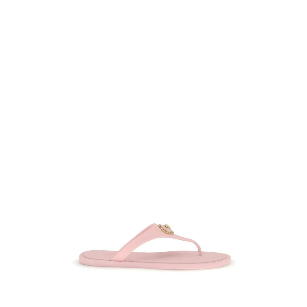 Light pink rubber Versace thong sandal with a gold Medusa head appliqué on the strap.
