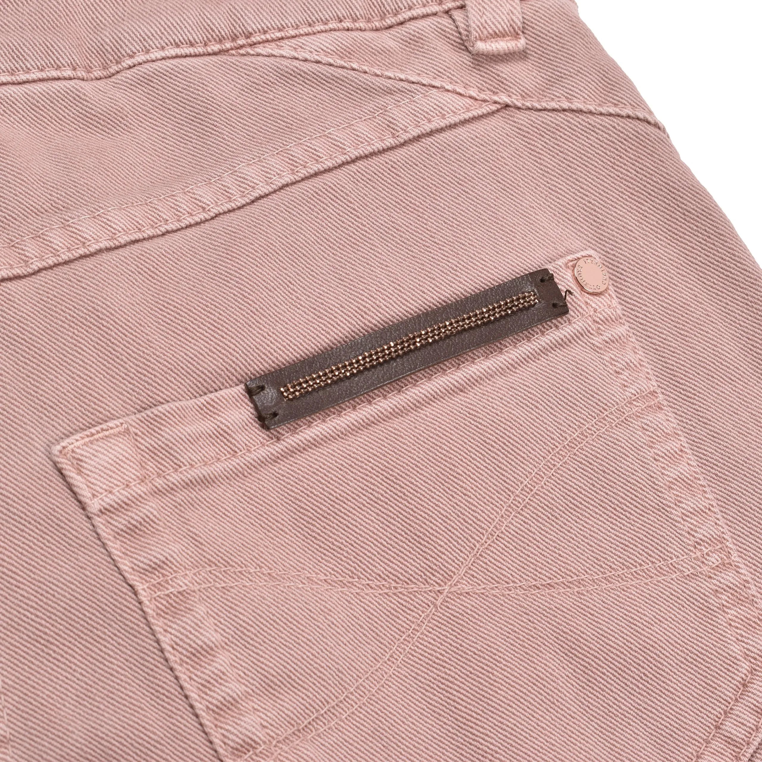 Pink sand cotton straight-leg jeans back pocket featuring a brown leather patch with beaded detail.