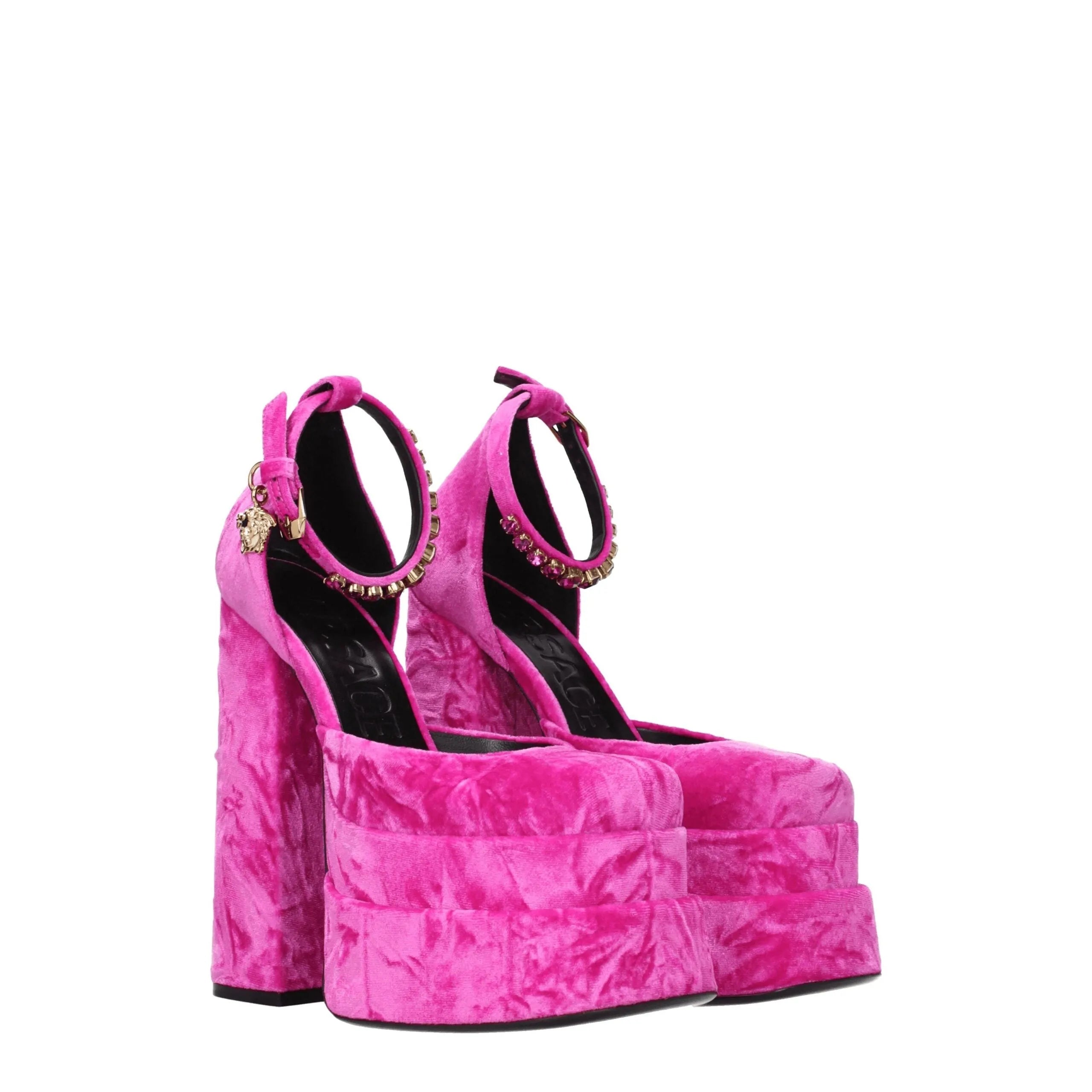 Pink velvet platform sandals featuring high block heels, ankle straps with gold buckles and rhinestone accents.