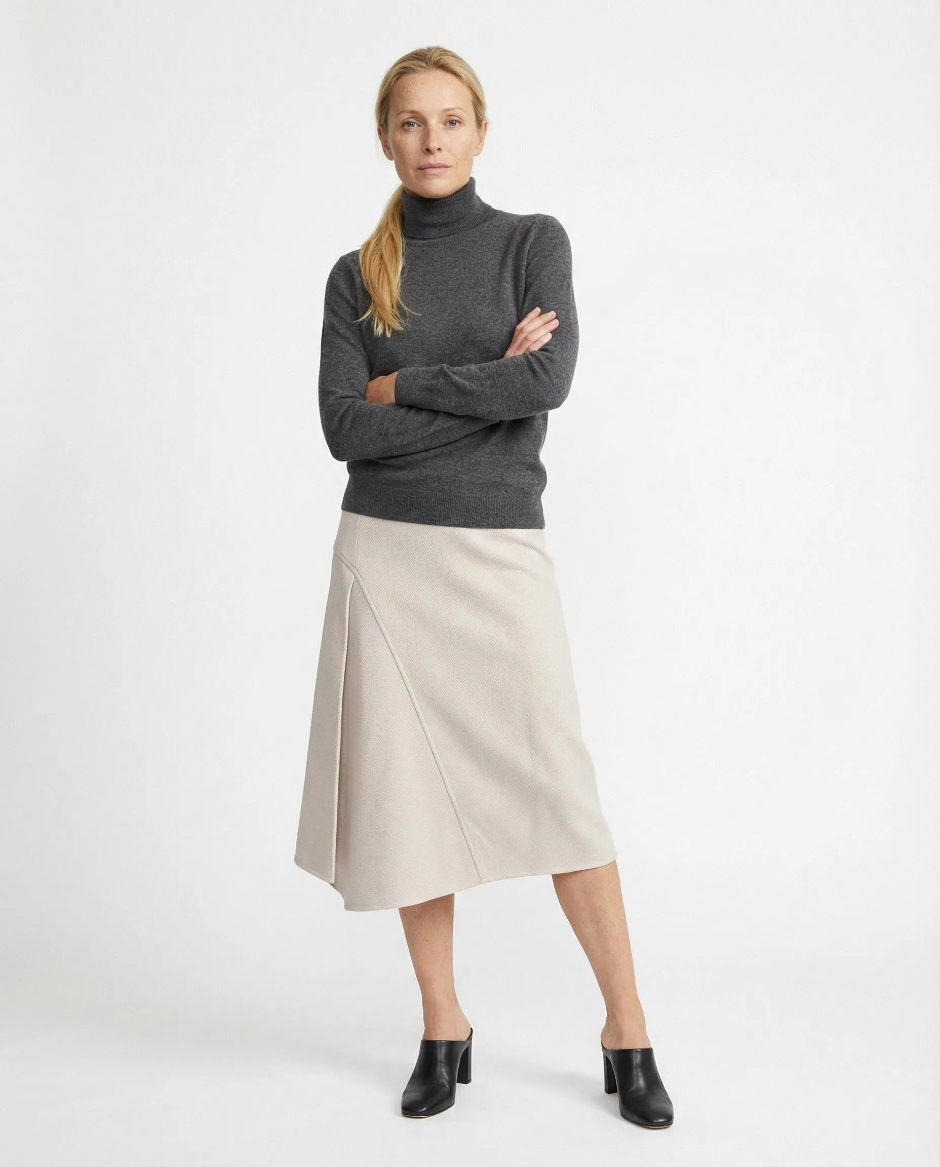 Light beige cotton midi skirt with A-line silhouette and diagonal front panel detail.