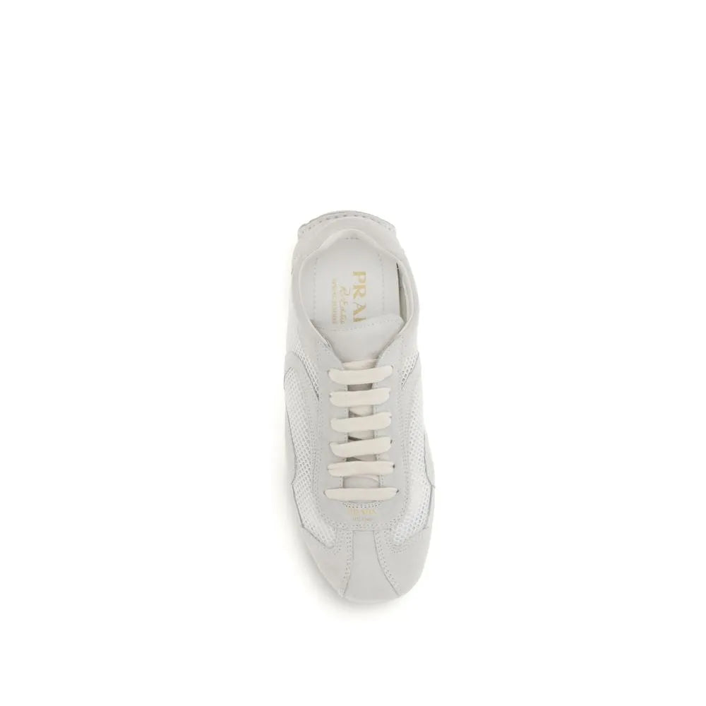 White Prada Montecarlo low top sneaker, crafted from mesh and suede, with lace-up front and prominent tongue logo.